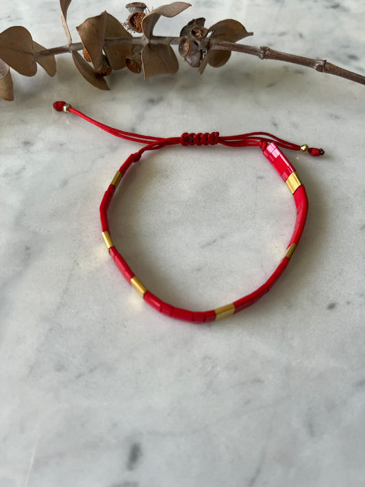 Pulsera cristales rojos y detalles en baño de oro, ajustable de 15cm a 20cm
