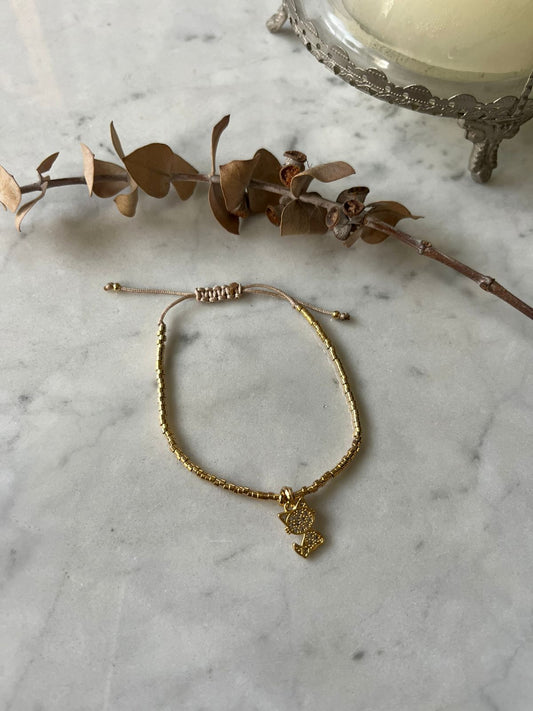 Pulsera hilo baño de oro 24 k con gato y circones